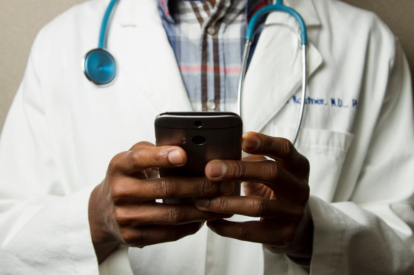 Doctor reviewing appointments on a phone